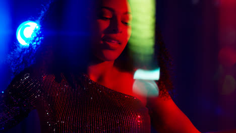 Close-Up-Of-Young-Woman-In-Nightclub-Bar-Or-Disco-Dancing-With-Sparkling-Lights